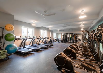 Gym with weightlifting equipment, treadmills, and ellipticals at the Residences at Bentwood in Plymouth Meeting