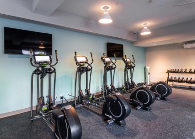 Gym with elliptical machines and kettle balls at the Residences at Bentwood in Plymouth Meeting