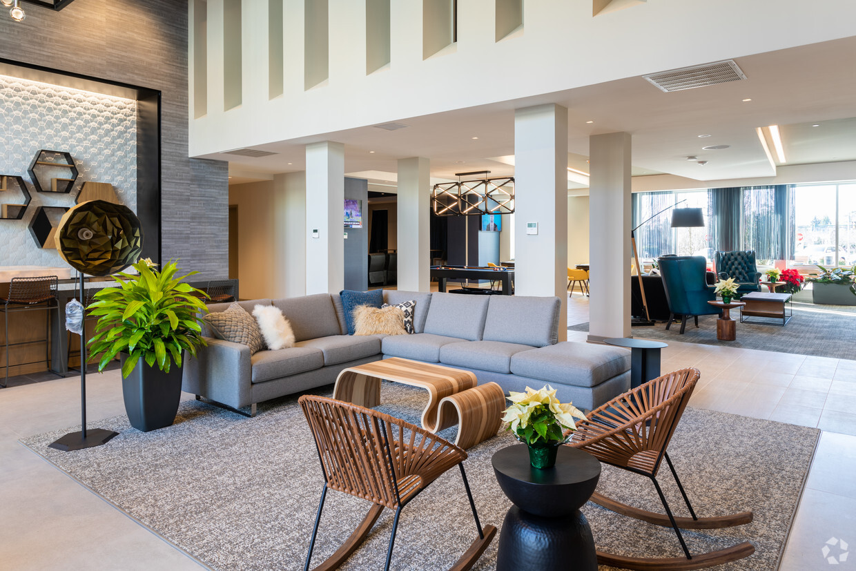A community lounge with a billiards table and multiple seating areas at The Residences at Bentwood.