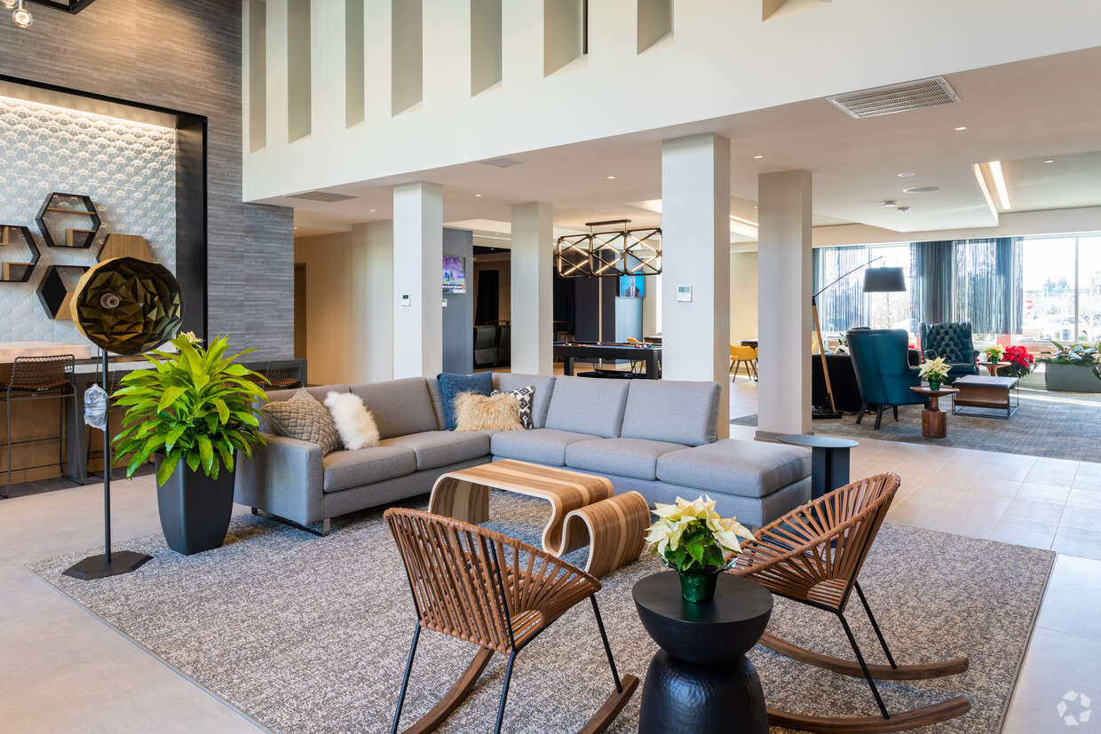 A community lounge with a billiards table and multiple seating areas at The Residences at Bentwood.