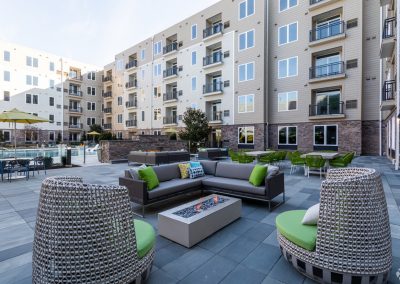 Outdoor lounge and dining area with fire pits at the Residences at Bentwood