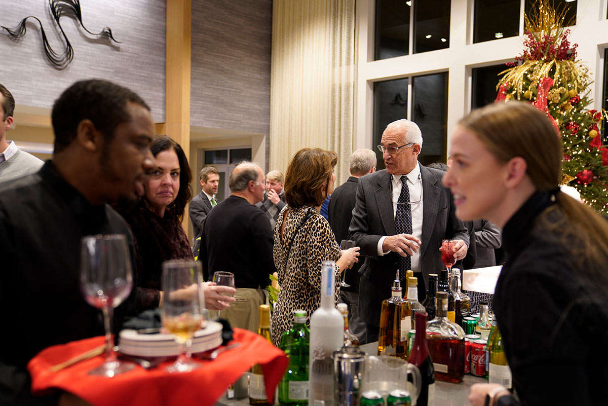 Residents attending a holiday party with catered food and drinks at The Residences at Bentwood.